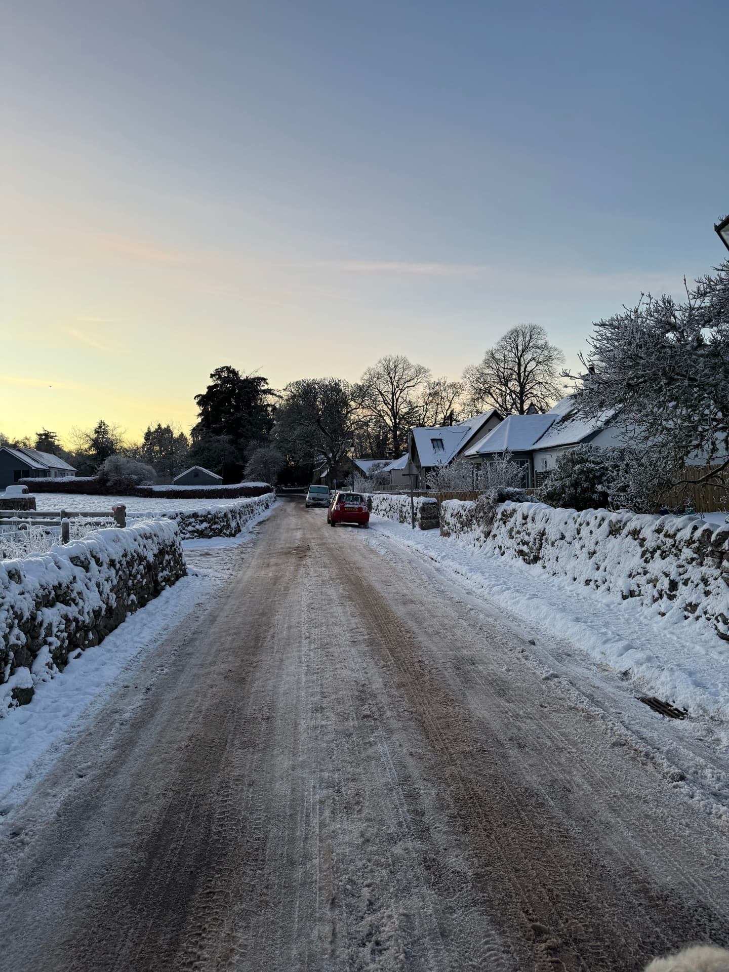 A snow-covered village road outside Nairn in winter